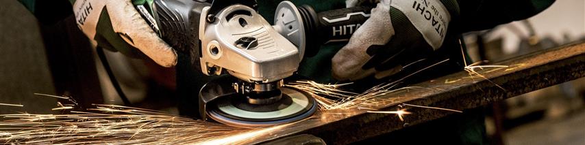 Tradesperson working at grinding metal in a workshop