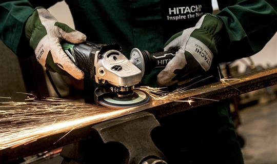 Tradesperson working at grinding metal in a workshop