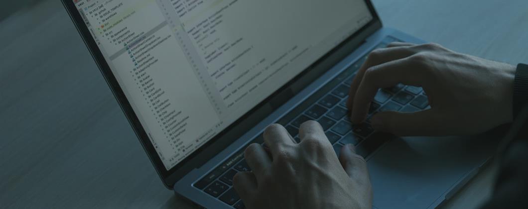 Remote Employee working on a computer covered by cyber insurance