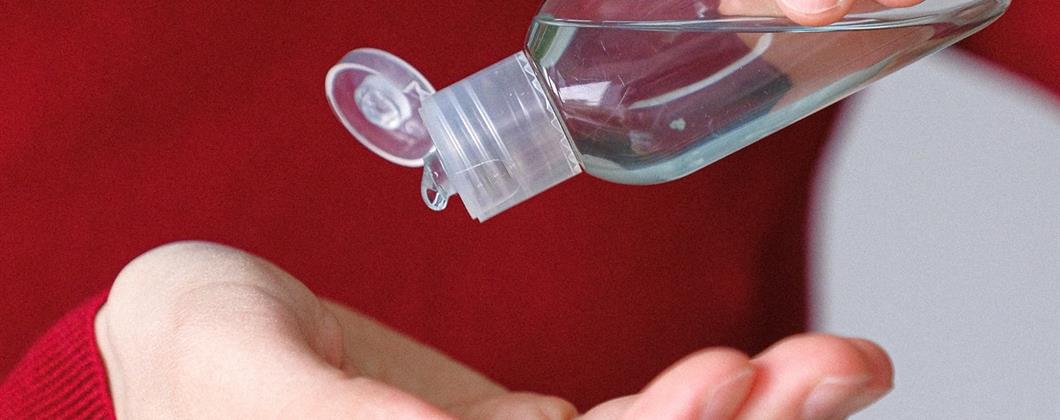 Insurance specialist washing hands with anti-bacterial gel